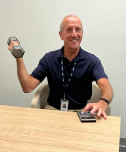 Man holding a barbell and calculator