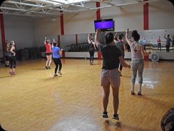 A group of people moving in unison in a group exercise program